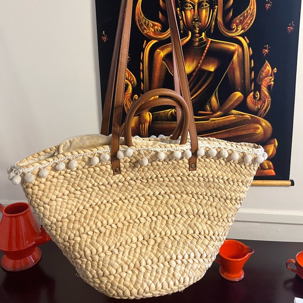 Crean natural woven straw cornhusk bag with puffs and brown straps